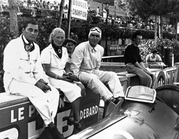 Successful Alfa private entrant Hans Ruesch sitting on the Monaco pit wall with a lady and Nino Farina.